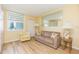 Sunlit living room features wood floors, a large window, comfortable seating and decor at 5729 Puerta Del Sol S Blvd # 185, St Petersburg, FL 33715