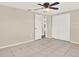 Bedroom featuring tile floors, a ceiling fan, and an ample closet space at 6017 6Th Ave, New Port Richey, FL 34653