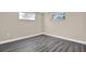 An empty bedroom area features neutral paint, laminate flooring and natural light at 6017 6Th Ave, New Port Richey, FL 34653