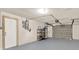 Attached garage featuring painted floors and interior access door at 6017 6Th Ave, New Port Richey, FL 34653