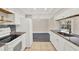 Bright kitchen with granite countertops, white cabinetry, and a full-sized refrigerator at 6017 6Th Ave, New Port Richey, FL 34653