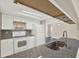 Updated kitchen with sleek granite countertops, white cabinets, and stainless steel sink at 6017 6Th Ave, New Port Richey, FL 34653