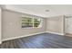 Large living room area with gray walls, laminate flooring, and a bright window at 6017 6Th Ave, New Port Richey, FL 34653