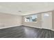 Inviting living room with luxury vinyl plank flooring, natural light, and a bright white front door at 6017 6Th Ave, New Port Richey, FL 34653