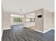 Spacious living room area with durable dark laminate flooring and natural light at 6017 6Th Ave, New Port Richey, FL 34653
