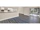 Open concept living area with durable dark laminate flooring and sliding glass door at 6017 6Th Ave, New Port Richey, FL 34653