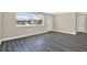 Bright living room featuring luxury vinyl plank flooring, natural light, and neutral walls at 6017 6Th Ave, New Port Richey, FL 34653