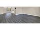 Spacious living area with luxury vinyl plank flooring, with neutral walls and an open layout at 6017 6Th Ave, New Port Richey, FL 34653