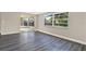 Open floor plan living room with laminate flooring and a large window for ample light at 6017 6Th Ave, New Port Richey, FL 34653