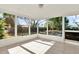 Enclosed sunroom featuring tiled floors and large windows offering lots of natural light at 6017 6Th Ave, New Port Richey, FL 34653