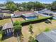 Aerial view of a backyard with a screened pool, lush landscaping and a well-maintained lawn at 603 Wood Rd, Seffner, FL 33584