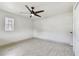 This bedroom has a ceiling fan, neutral paint, and a bright window at 603 Wood Rd, Seffner, FL 33584