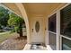 Inviting front entrance with a decorative glass door, complemented by a neutral 'WELCOME' mat and trimmed in beige at 603 Wood Rd, Seffner, FL 33584