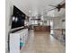 Open-concept living room featuring tile floors, modern furniture, and a large flat-screen TV mounted on the wall at 603 Wood Rd, Seffner, FL 33584