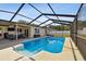 A backyard featuring a screened in pool, an extended patio with room for seating at 603 Wood Rd, Seffner, FL 33584