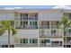 Balconies feature comfortable seating options with tropical palm tree landscape at 6081 Bahia Del Mar Cir # 452, St Petersburg, FL 33715