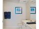 Bright bathroom featuring sleek countertops, nautical artwork, and modern fixtures at 6081 Bahia Del Mar Cir # 452, St Petersburg, FL 33715