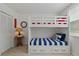 Bunk beds with red, white, and blue accents, complemented by nautical decor, create a playful bedroom setting at 6081 Bahia Del Mar Cir # 452, St Petersburg, FL 33715