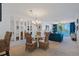 Dining area with wicker chairs, glass table, and a view of the living room at 6081 Bahia Del Mar Cir # 452, St Petersburg, FL 33715