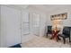Condo entry featuring a glass table, two chairs, laundry closet, and tiled floor at 6081 Bahia Del Mar Cir # 452, St Petersburg, FL 33715