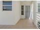 Exterior view of a tiled condo entryway with a white door and sidelight window at 6081 Bahia Del Mar Cir # 452, St Petersburg, FL 33715