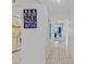 Bright condo hallway leading to living area with view, nautical-themed wall decor at 6081 Bahia Del Mar Cir # 452, St Petersburg, FL 33715