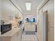 Bright kitchen with white cabinets, appliances, and a view to the living area at 6081 Bahia Del Mar Cir # 452, St Petersburg, FL 33715
