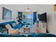 Bright living room with cozy blue furnishings, water view, and lots of natural light at 6081 Bahia Del Mar Cir # 452, St Petersburg, FL 33715