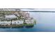 Aerial view of a condo building on the water surrounded by lush landscaping and mature palm trees at 6287 Bahia Del Mar Cir # 404, St Petersburg, FL 33715