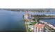 Aerial view of waterfront condo building, lush lawns, pools, and boat dock at 6287 Bahia Del Mar Cir # 404, St Petersburg, FL 33715