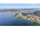 Aerial view of a condo building on the water with a lake, bridge, and city skyline at 6287 Bahia Del Mar Cir # 404, St Petersburg, FL 33715