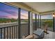 Cozy balcony features outdoor seating and sunset views of the lake and palm trees at 6287 Bahia Del Mar Cir # 404, St Petersburg, FL 33715