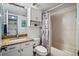 Bathroom featuring granite vanity, nautical shower curtain, and white cabinets at 6287 Bahia Del Mar Cir # 404, St Petersburg, FL 33715