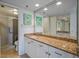 The bathroom features a granite countertop, white cabinets, and an accessible shower at 6287 Bahia Del Mar Cir # 404, St Petersburg, FL 33715