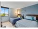Cozy bedroom featuring two beds, neutral walls, and a window with a serene view at 6287 Bahia Del Mar Cir # 404, St Petersburg, FL 33715