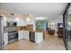 An open-concept kitchen features stainless steel appliances, granite countertops, and a view to the living room at 6287 Bahia Del Mar Cir # 404, St Petersburg, FL 33715