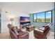 Living area with comfortable seating, media center, and a large window with a lush outdoor view at 6287 Bahia Del Mar Cir # 404, St Petersburg, FL 33715