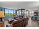 Inviting living room featuring comfortable leather seating, and floor-to-ceiling windows with scenic views at 6287 Bahia Del Mar Cir # 404, St Petersburg, FL 33715