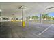 Open and bright parking garage with yellow support beams and parking space stops at 6287 Bahia Del Mar Cir # 404, St Petersburg, FL 33715