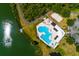 Aerial view of community pool and clubhouse with sand volleyball court and access to the lake at 7132 Colony Pointe Dr, Riverview, FL 33578