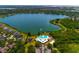 Breathtaking aerial view of a community pool, a lake with fountain, lush greenery, and surrounding homes in the area at 7132 Colony Pointe Dr, Riverview, FL 33578