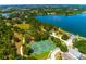 Aerial view features the neighborhood tennis courts, baseball field, and walking path surrounding the lake at 7132 Colony Pointe Dr, Riverview, FL 33578