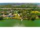 Aerial view of a lakefront home, dock, community tennis court and easy highway access at 7132 Colony Pointe Dr, Riverview, FL 33578