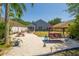 The spacious backyard boasts a cozy seating area, a charming porch swing, and easy-to-maintain landscaping at 7132 Colony Pointe Dr, Riverview, FL 33578