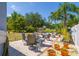 Backyard features patio with seating and lush tropical landscaping at 7132 Colony Pointe Dr, Riverview, FL 33578