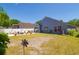 Spacious backyard offers a patio area with outdoor seating, gardening space, and lush greenery, creating a serene retreat at 7132 Colony Pointe Dr, Riverview, FL 33578