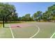 Outdoor basketball court features a green and red painted surface and several basketball hoops at 7132 Colony Pointe Dr, Riverview, FL 33578