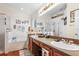 Bathroom featuring double vanity, soaking tub, glass shower, and nautical decor at 7132 Colony Pointe Dr, Riverview, FL 33578