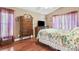 Cozy bedroom with floral bedding, wooden furniture, and bright natural light at 7132 Colony Pointe Dr, Riverview, FL 33578