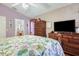 Bedroom with floral quilt, wooden furniture, and plenty of natural light at 7132 Colony Pointe Dr, Riverview, FL 33578
